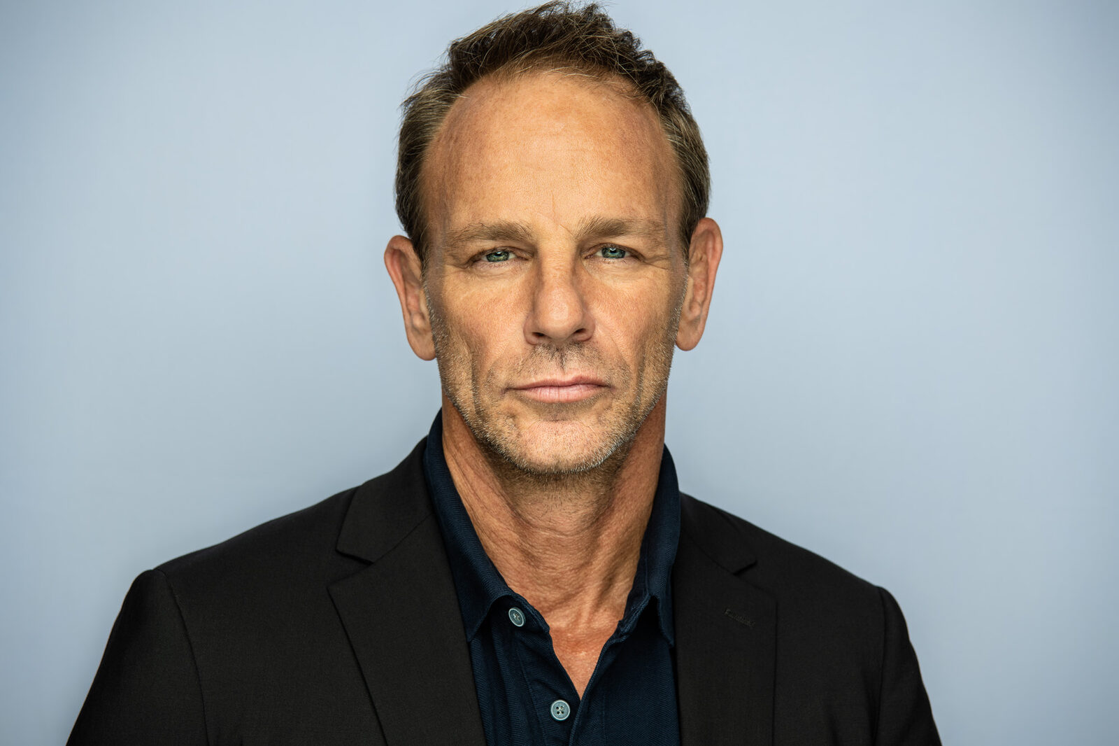 Actor headshot of David in a black blazer