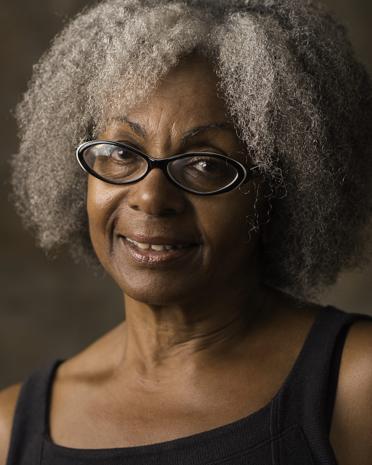 Dramatic actor headshot of Heather against a dark textured background